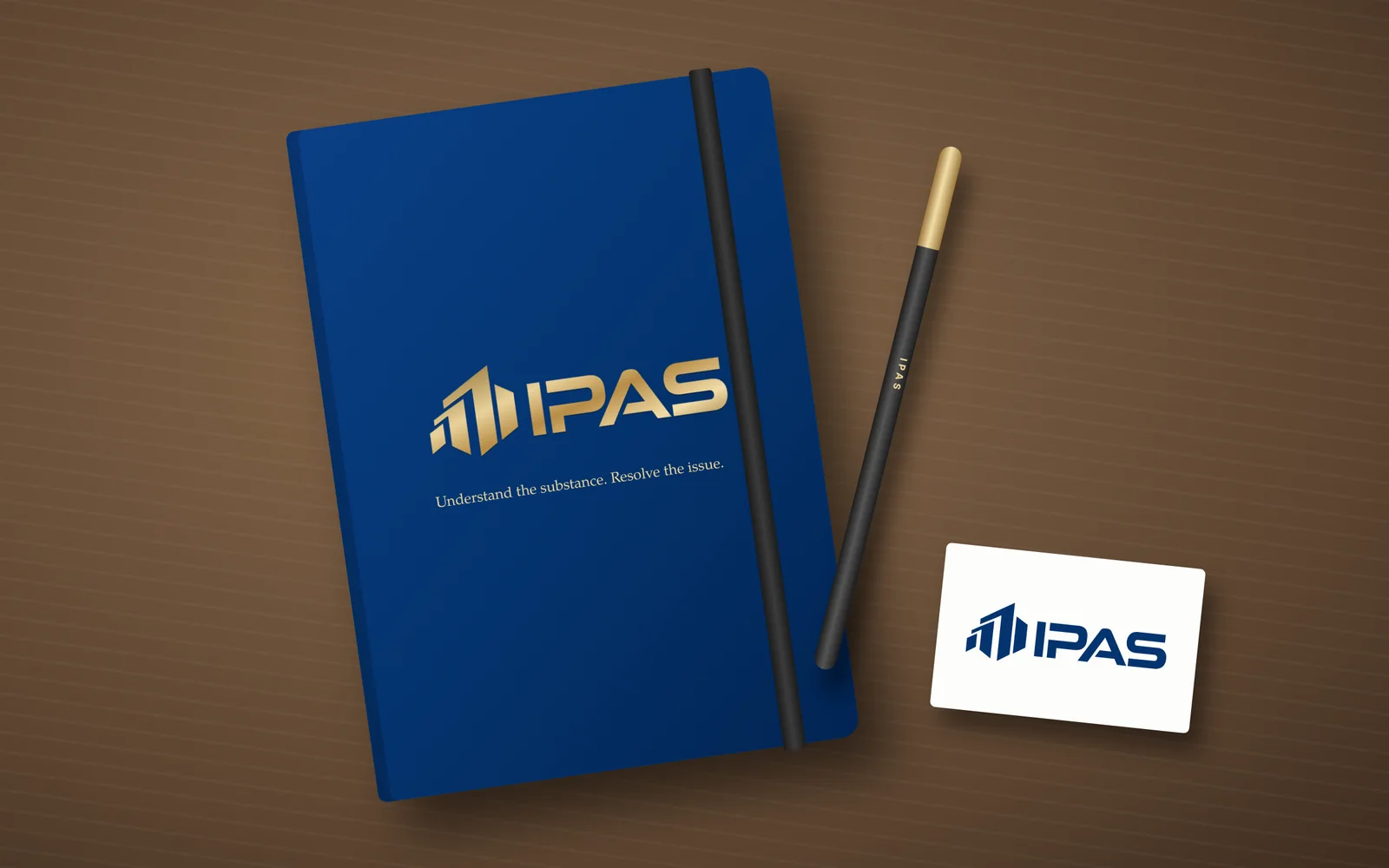 IPAS logo and slogan on a navy notebook